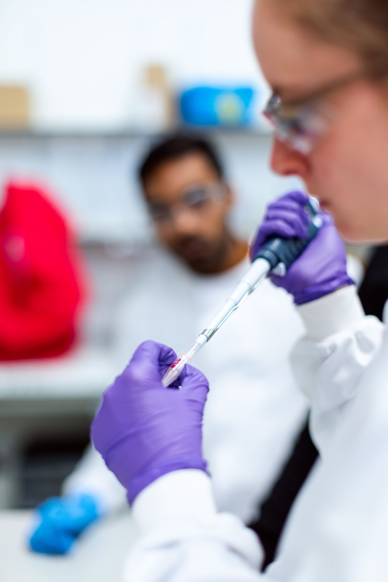 Scientist pipetting a sample at the bench